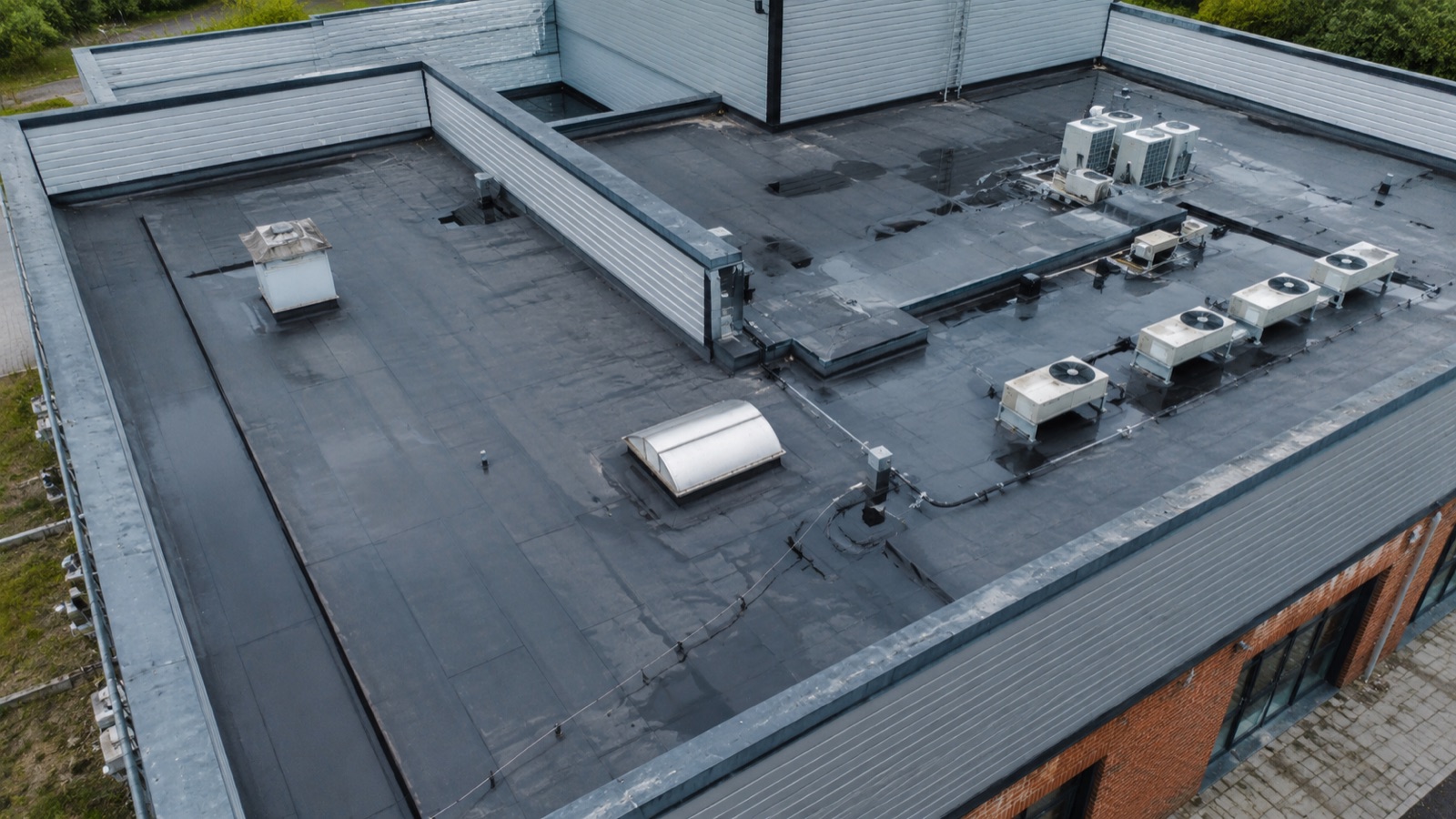 Drone-captured view of a commercial roof and façade inspection
